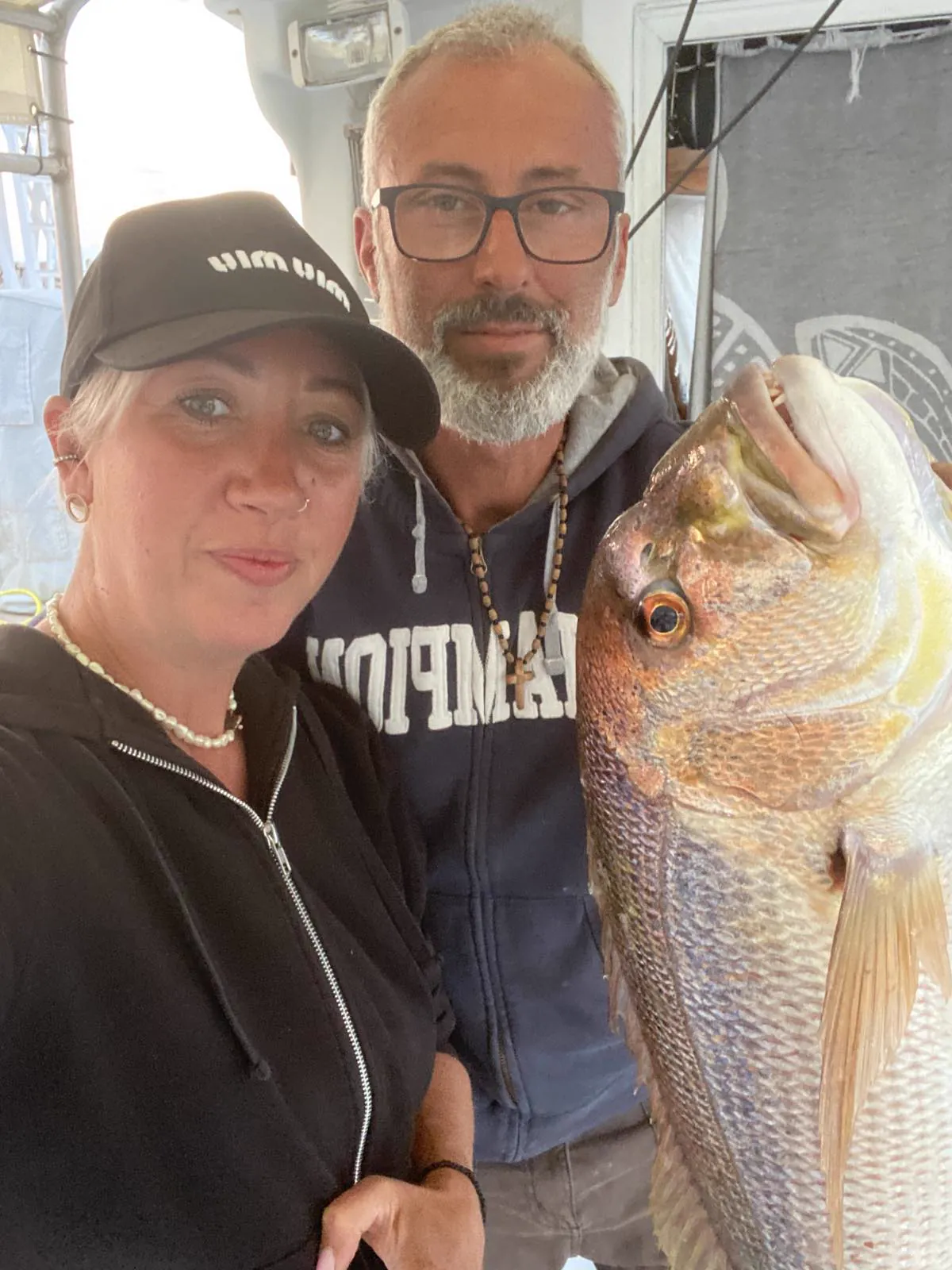 Our crew posing with a large fish on the boat