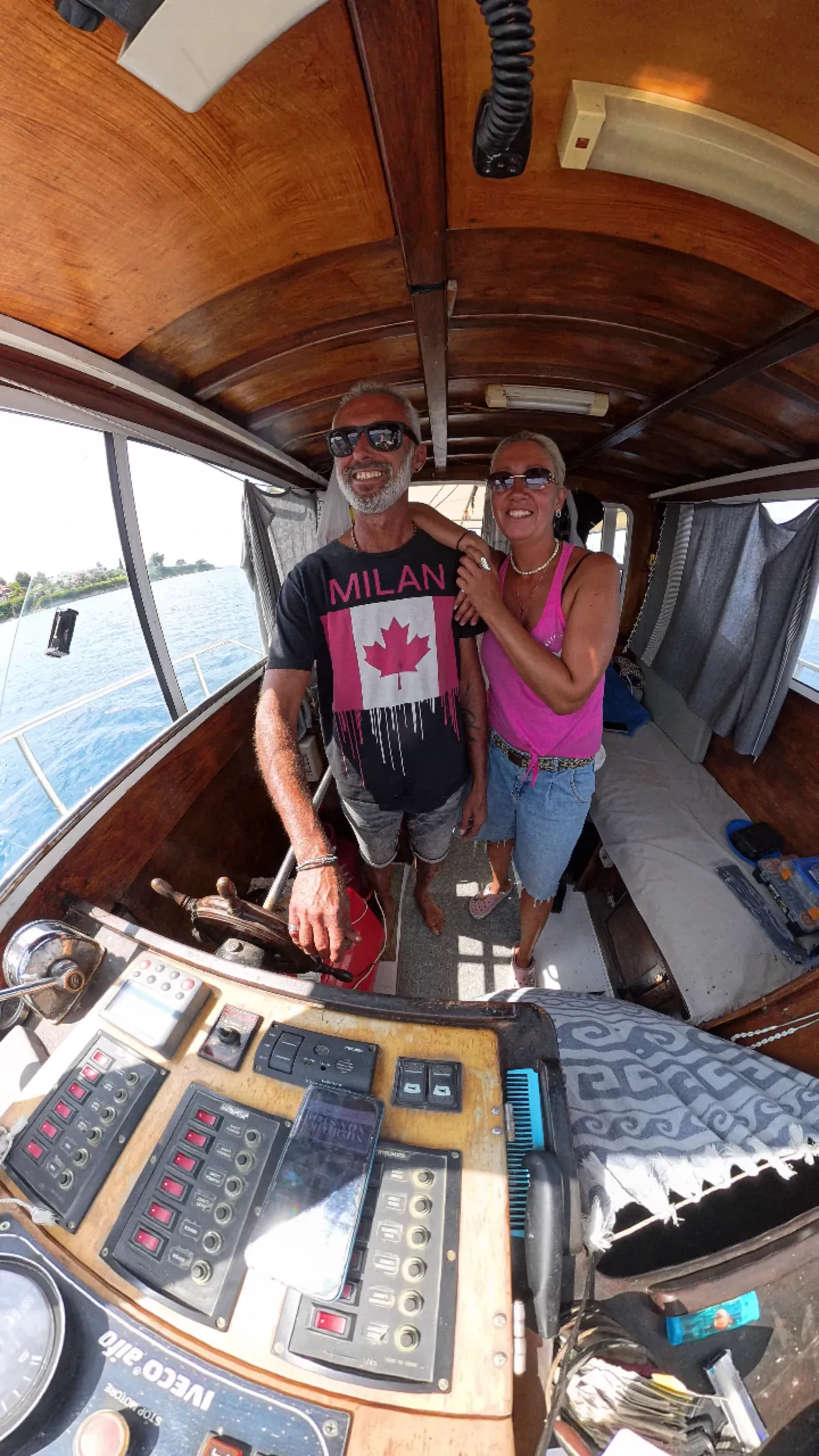 Our crew together at the helm of the boat