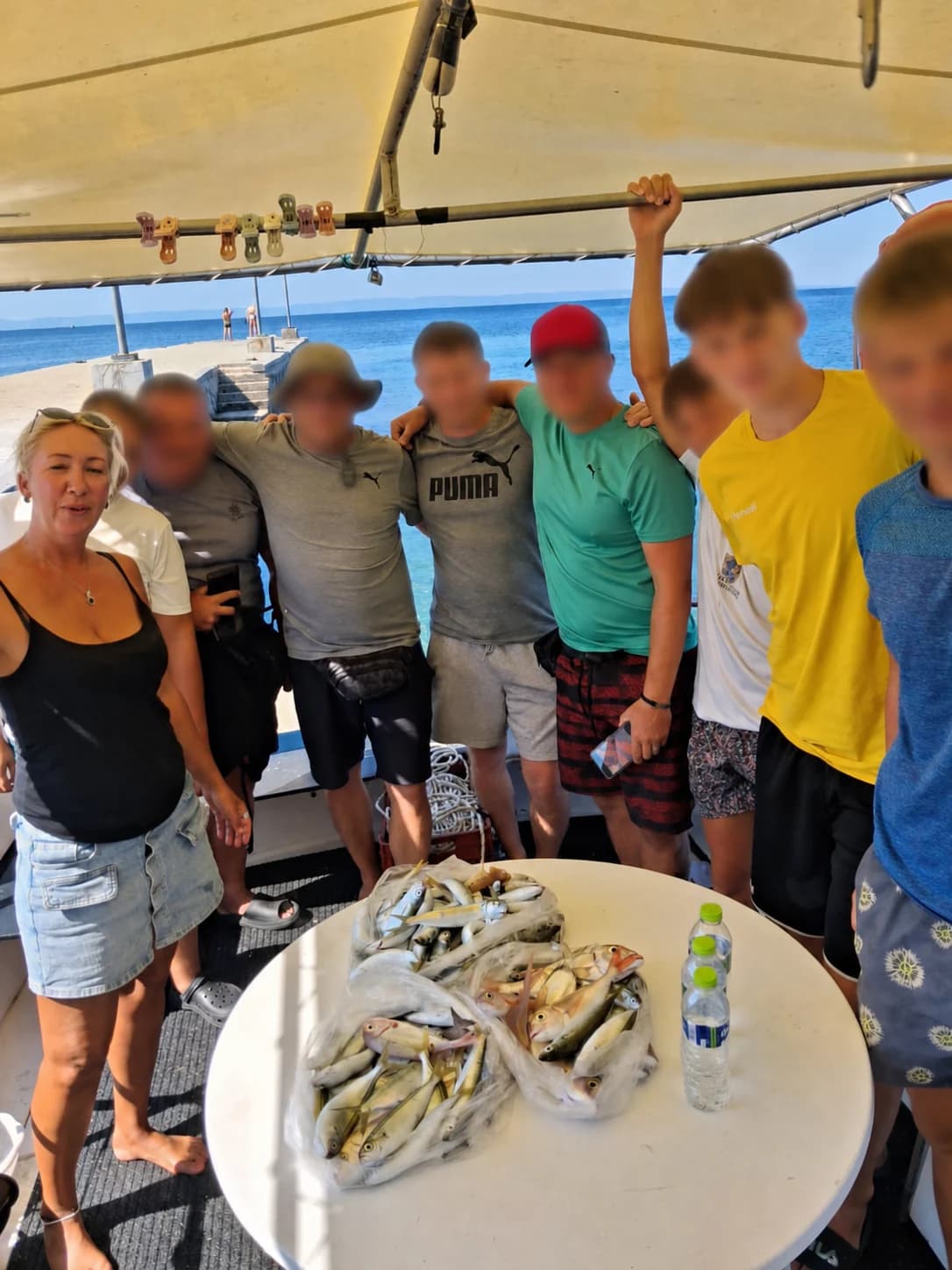 Veronika with friends beside the catch on the boat